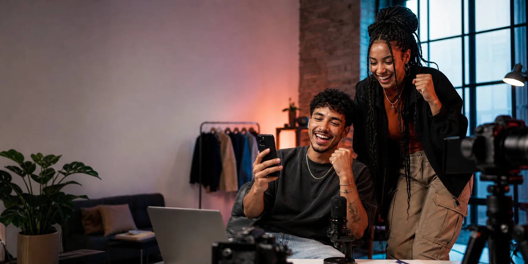 Creators in a studio celebrating a paid content drop