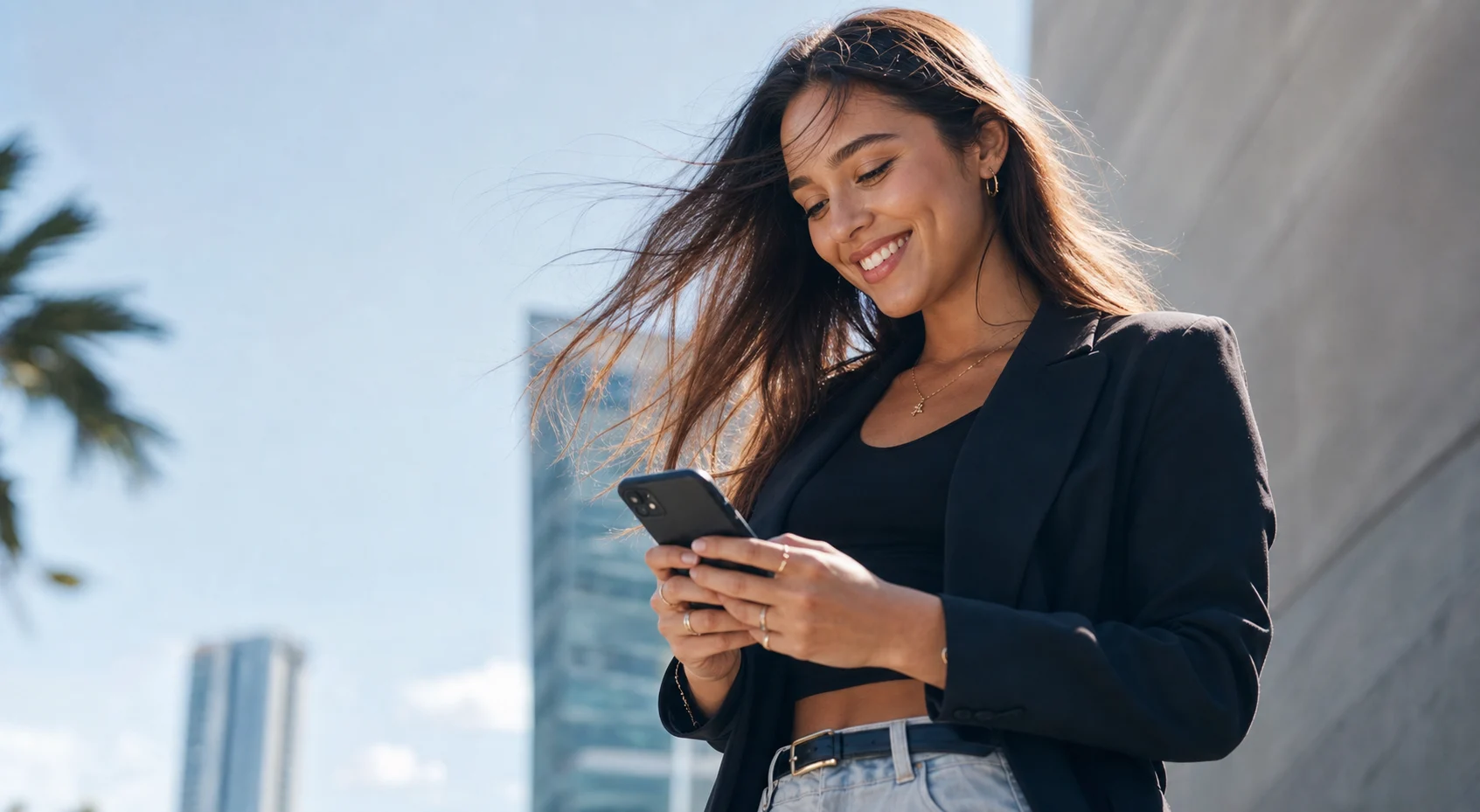 A smiling creator checking her phone after getting paid